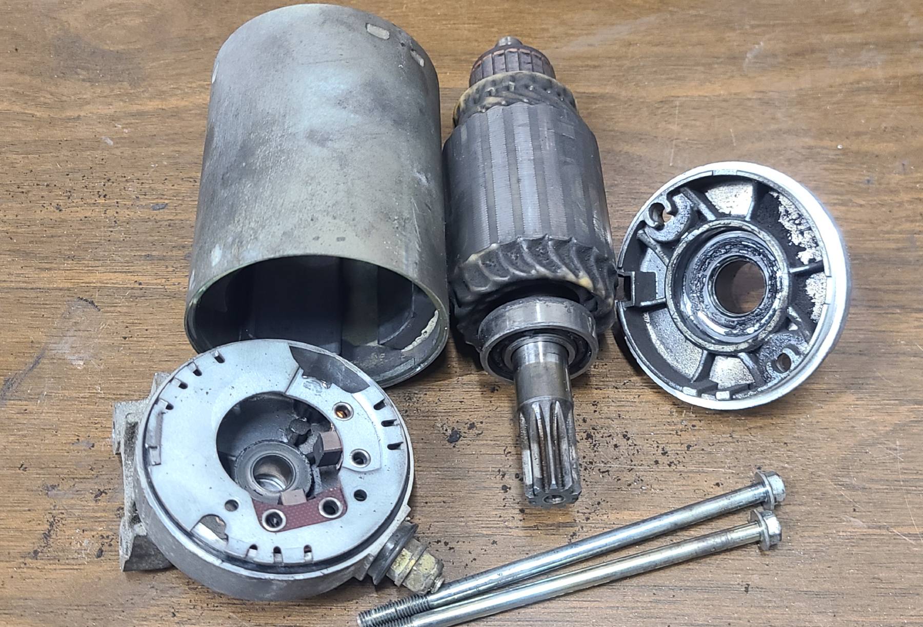 BMW K1100 starter motor dismantled before its refresh, with dirty housing and armature