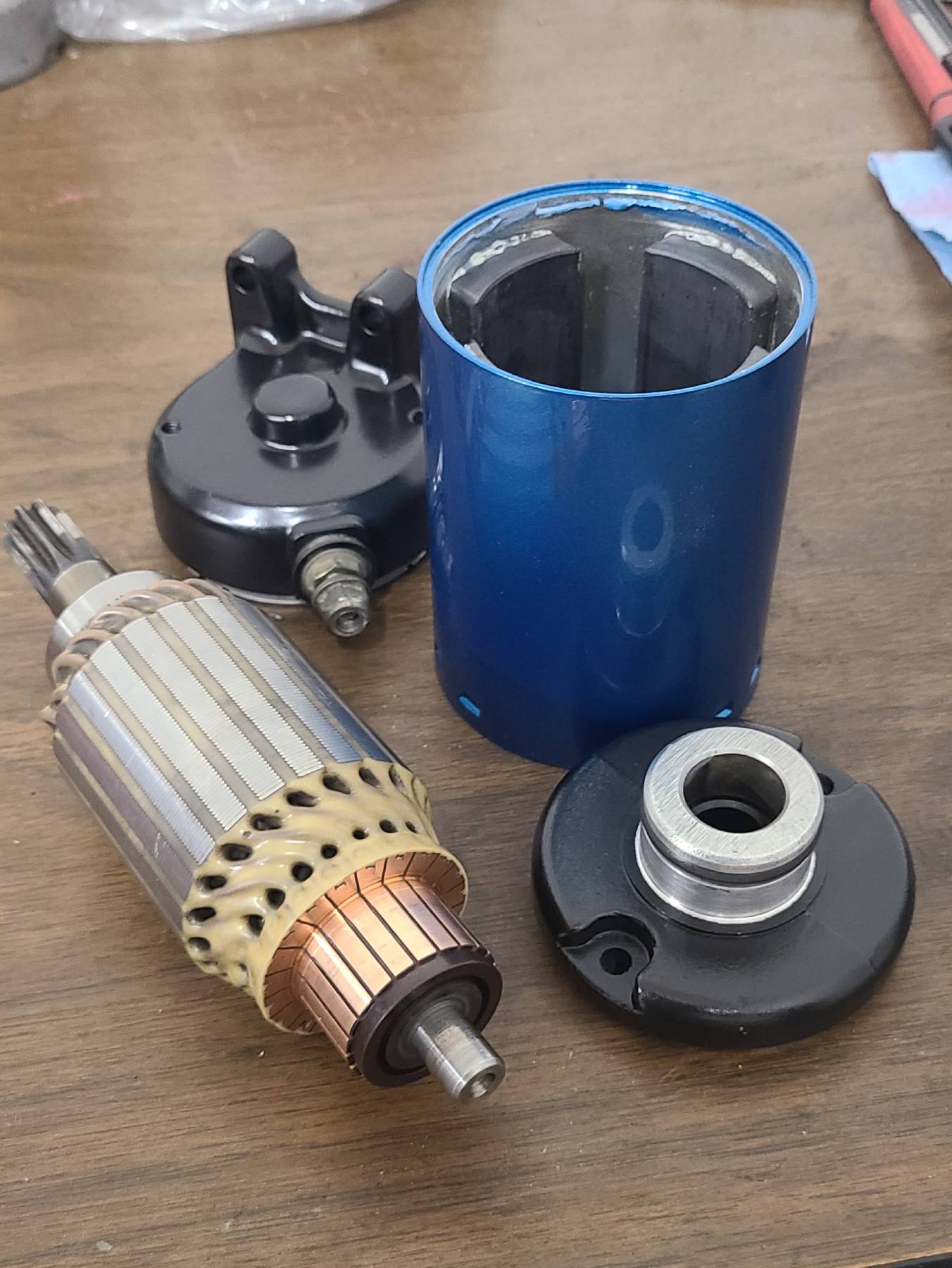 Cleaned and refinished starter parts after the refresh, including the armature and painted housing