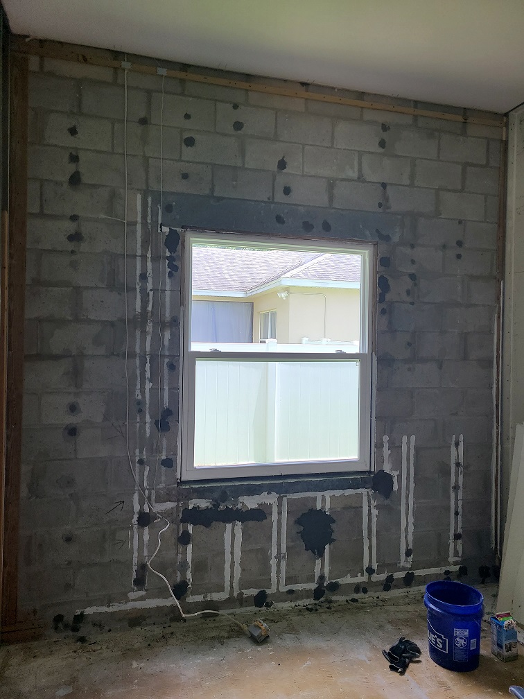 Exposed cinder block wall during studio construction